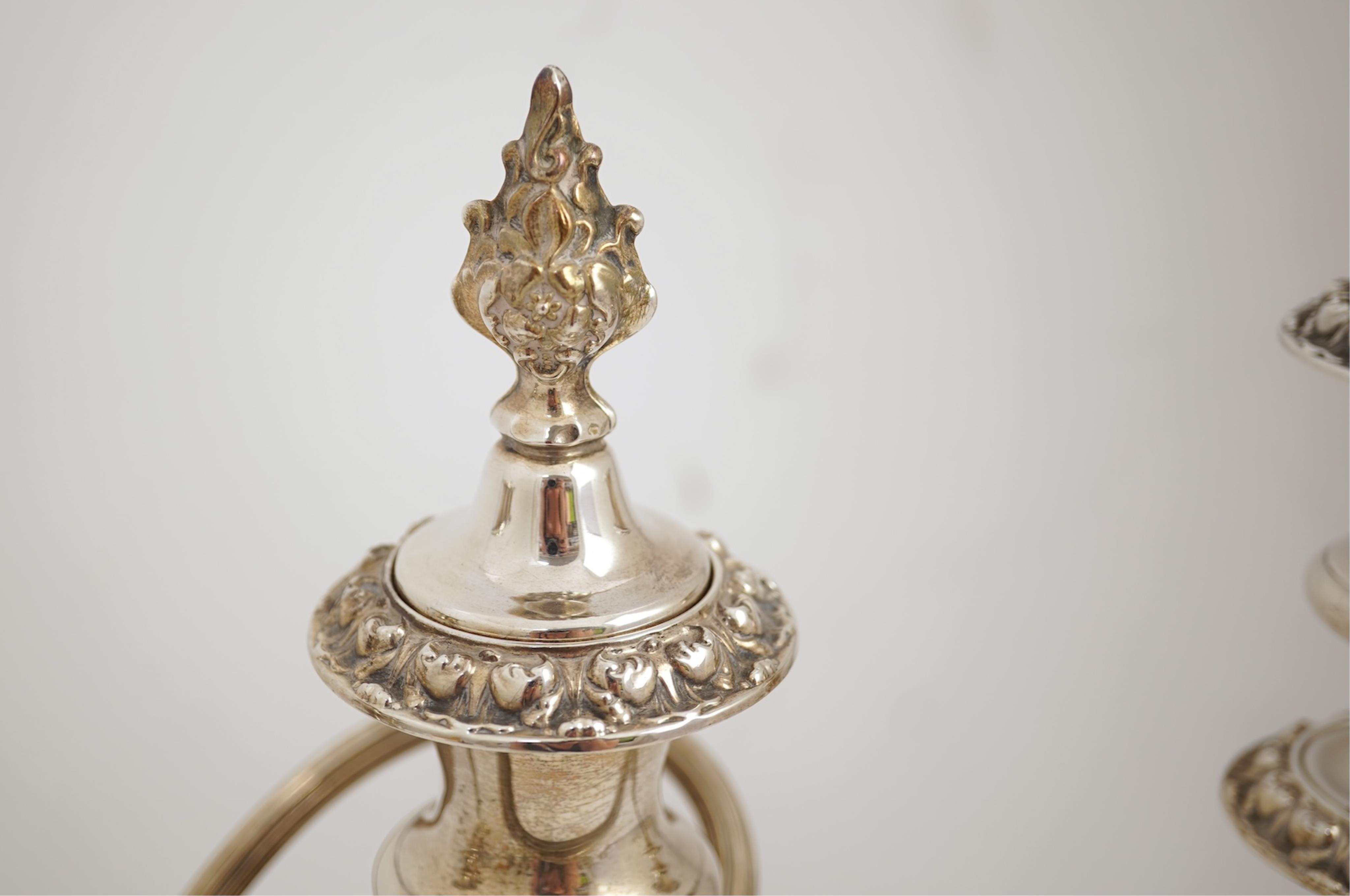 A pair of Elizabeth II silver dwarf two branch, three light candelabra by Barker Brothers Silver Co